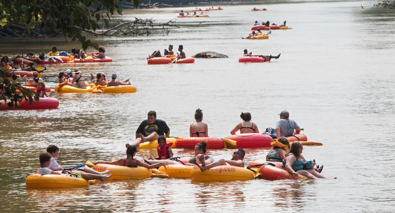 Duluth, GA / USA - July 14, 2018:  Several groups of people float down the Chattahoochee River on rafts and innertubes at the Whatever Floats Your Boat event on July 14, 2018 in Duluth, GA.